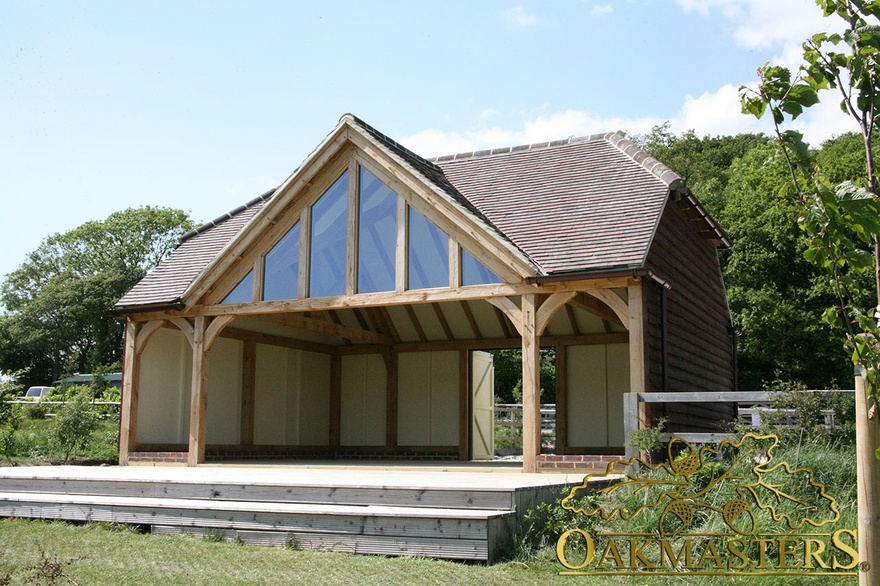Oak-frame amenity building with oak cladding and barn doors to rear