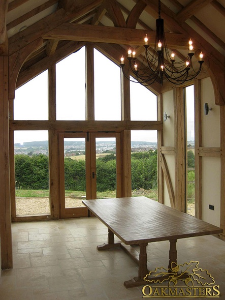 Glazed gable and full height windows, vaulted ceiling and raised tie oak trusses in glazed gable extension Isle of Wight