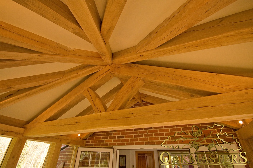 Detail of handcrafted oak beams rafters and truss in hexagonal garden room