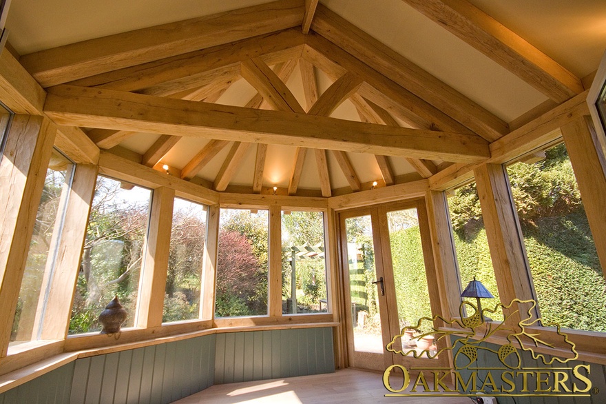 Interior hexagonal garden-room with exposed timber rafter and kingpost truss