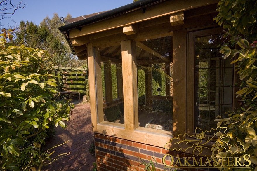 Timber roof and oak-frame glazed window detail on hexagonal garden room