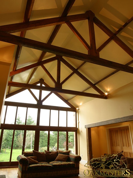 High vaulted ceiling with handcrafted oak truss before fully glazed gable window