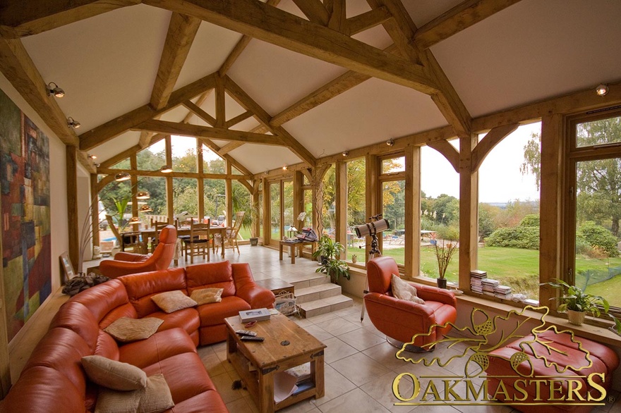 Raised tie trusses compliment glazed gable end in multi level garden room