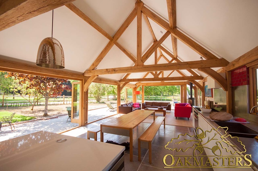 Modern kitchen with oak frame exposed truss open ceiling and oak frame glazing