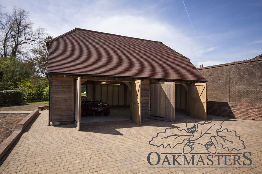 Both bays are closed and feature double oak garage doors