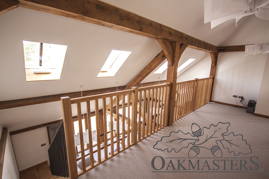 Top of the staircase opens onto a large landing with oak posts and brackets
