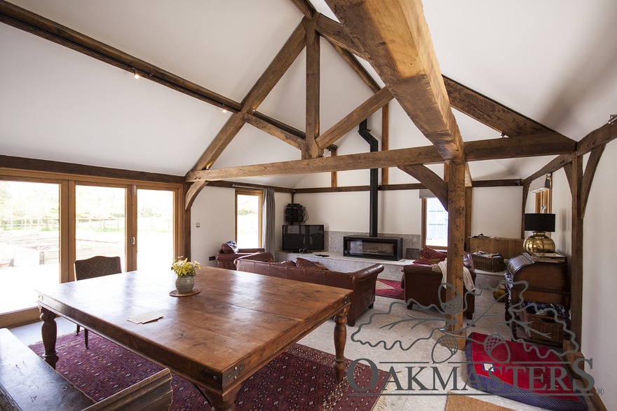 Classic vaulted ceiling design using oak king post trusses, oak posts and oak purlins