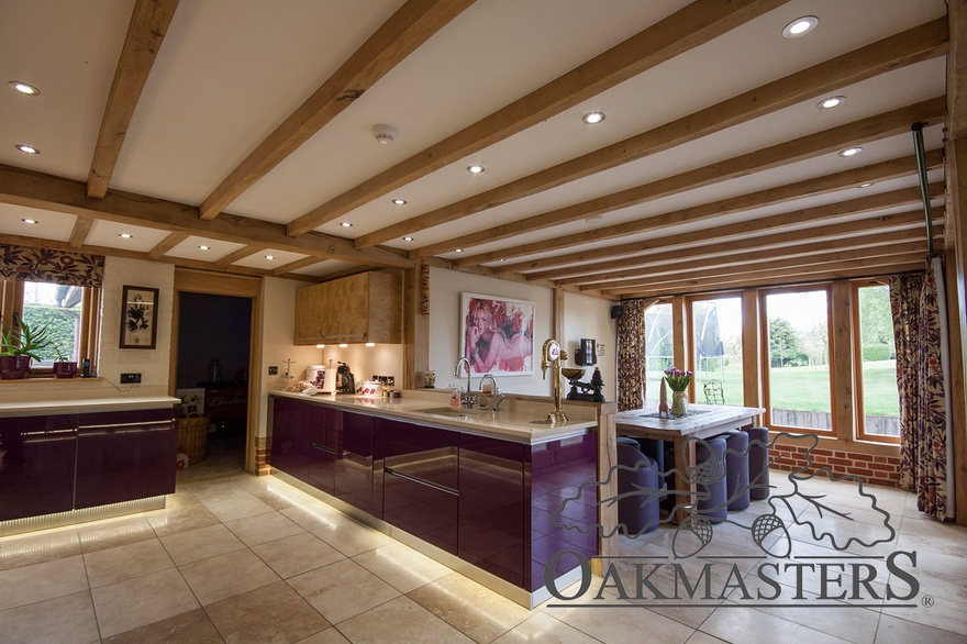 The open plan kitchen diner has a large oak window flooding the dining area with natural light