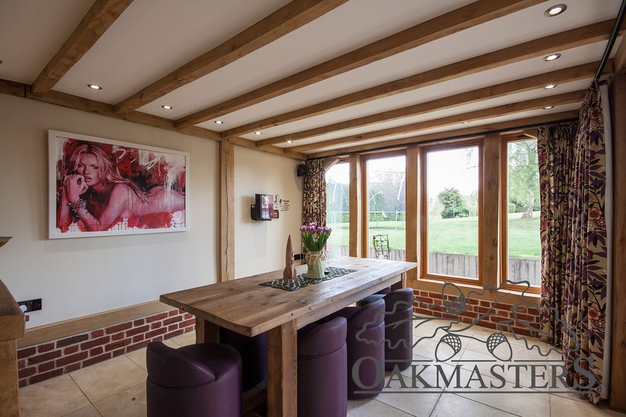 Dining space with oak ceiling beams and exposed structural oak frame