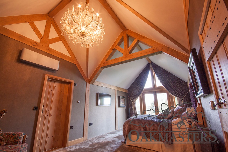 Master bedroom with vaulted oak ceiling and exposed oak roof trusses