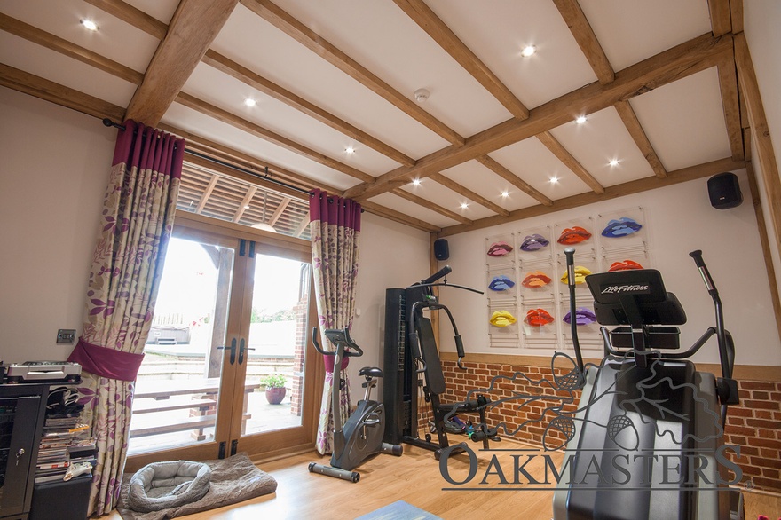 Stunning gym with oak ceiling beams and oak french doors