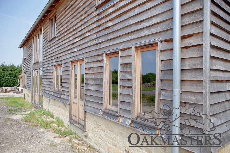 The barn is clad with oak feathr edge cladding all around