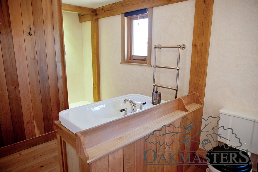 Structural oak frame is also exposed in the family bathroom