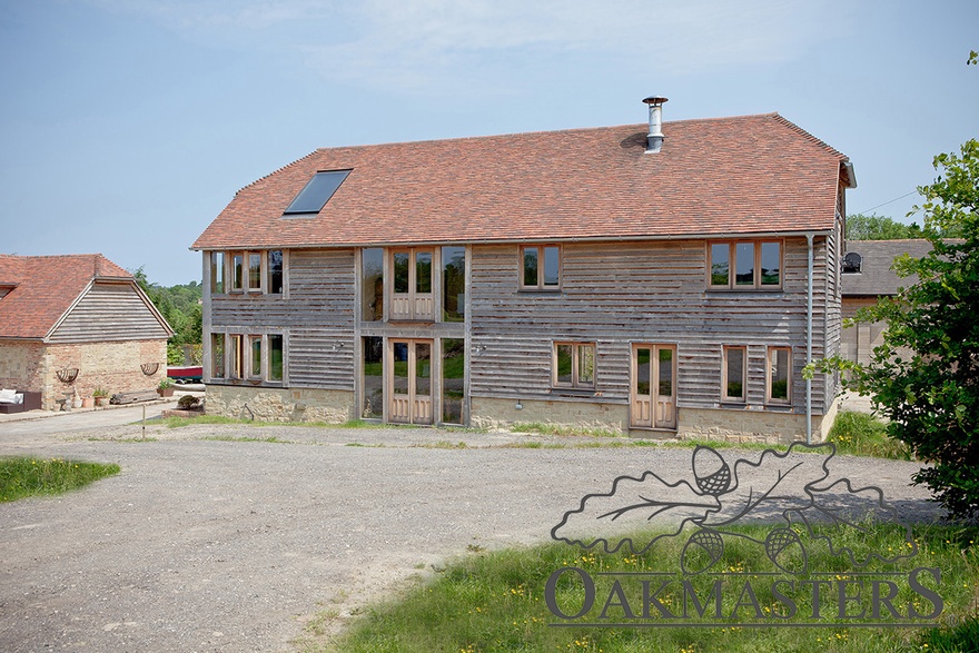 Windows and glazed areas are concentrated at the back of the oak barn to maximise the views