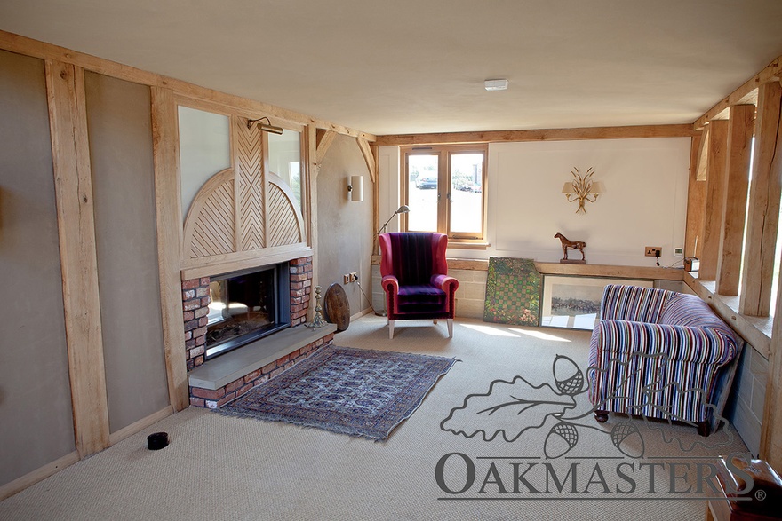 The entrance hall features a through wood-burning stove inset in the structural oak frame
