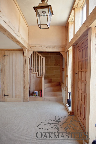 A hidden oak stairwell in the corner of the entrance hall