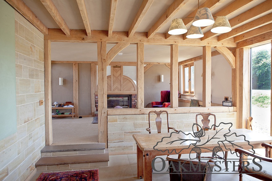 The open plan kitchen diner is connected to the entrance hall through an open oak framed screen