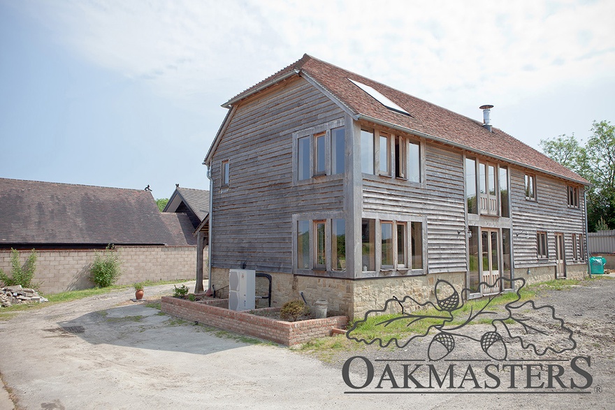Wrap around oak windows open the kitchen and the master bedroom to uninterrupted views over the countryside