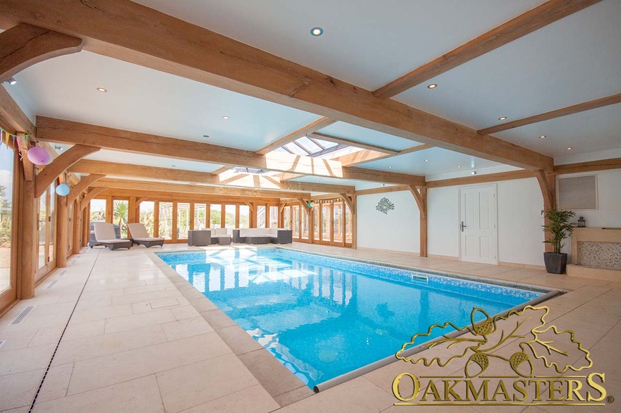 Oak framed pool house features a flat roof spanning 9 metres