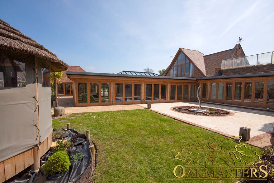 The oak framed pool house is glazed on three sides