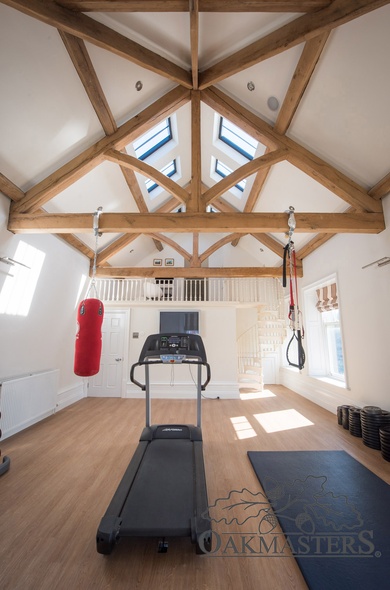 The gym room's oak ceiling allows natural light to flood in through the roof lights