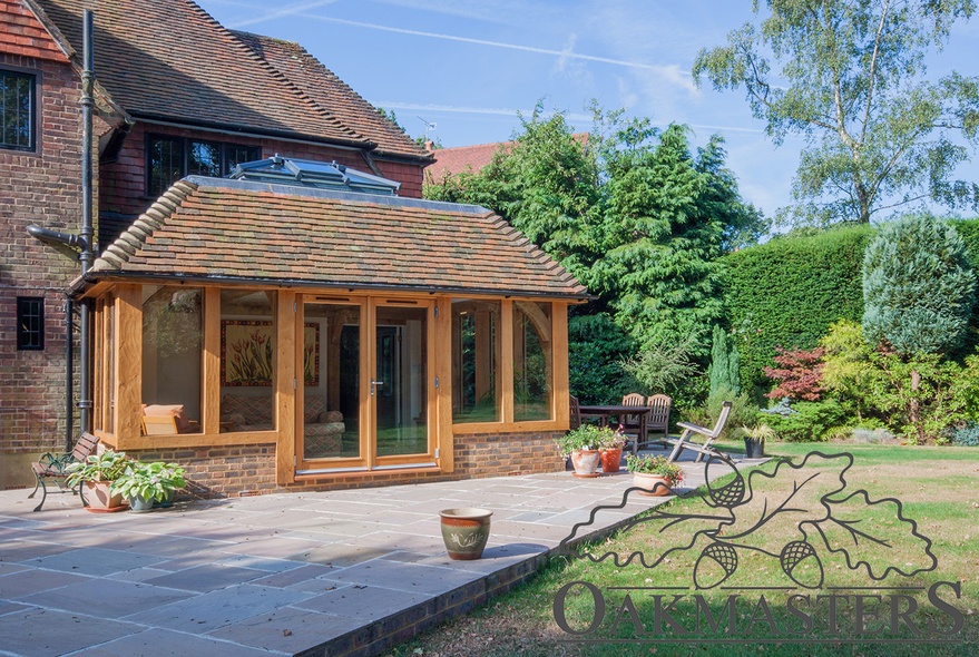 The oak framed structure is glazed on all three sides and features an oak french door