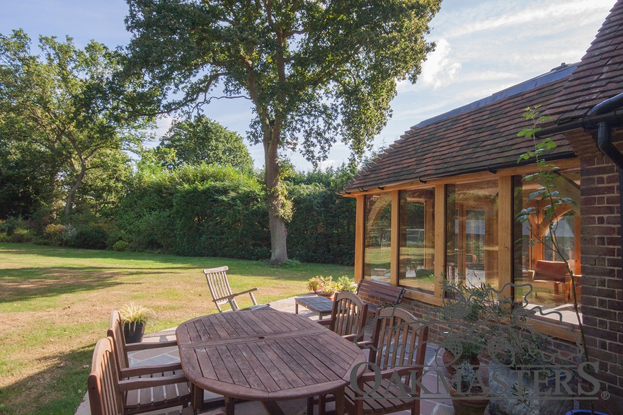 The patio outside the oak framed orangery has an outdoor dining space