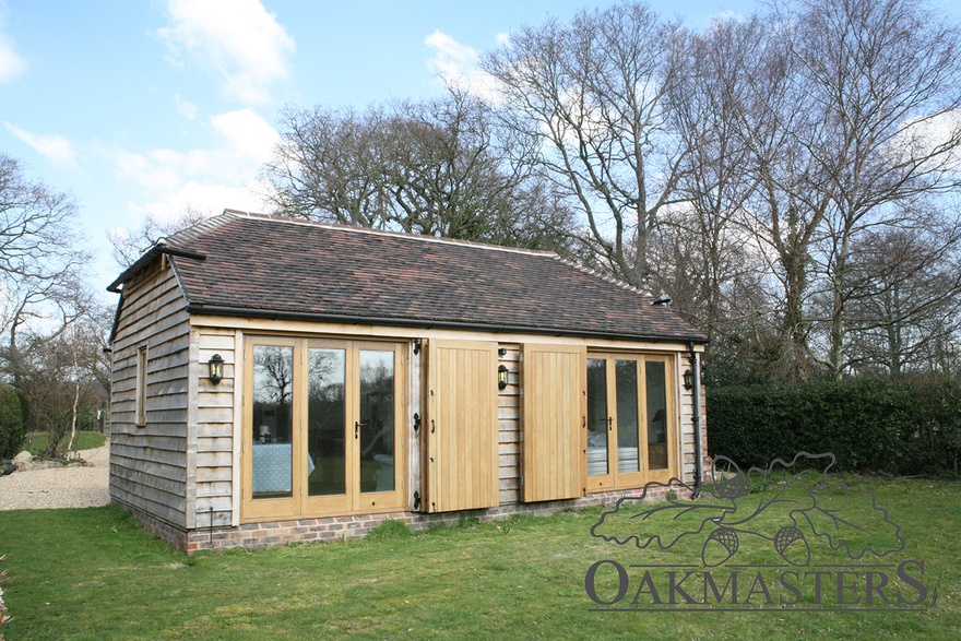 The oak garden room is part of an L-shaped complex incorporating also a garage