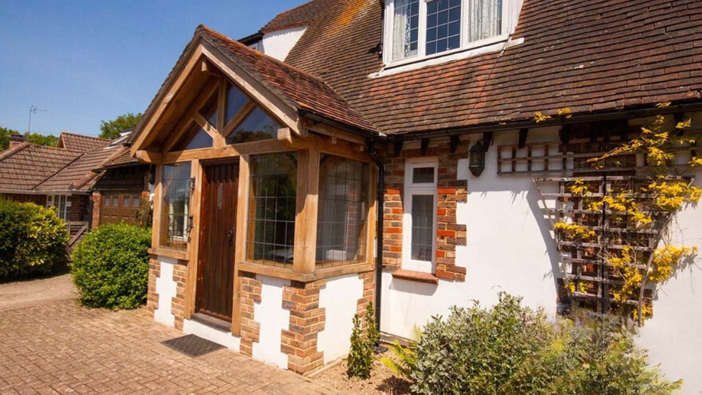An oak porch, crafted to your specifications, creating a welcoming entryway with this bespoke enclosed oak framed porch.