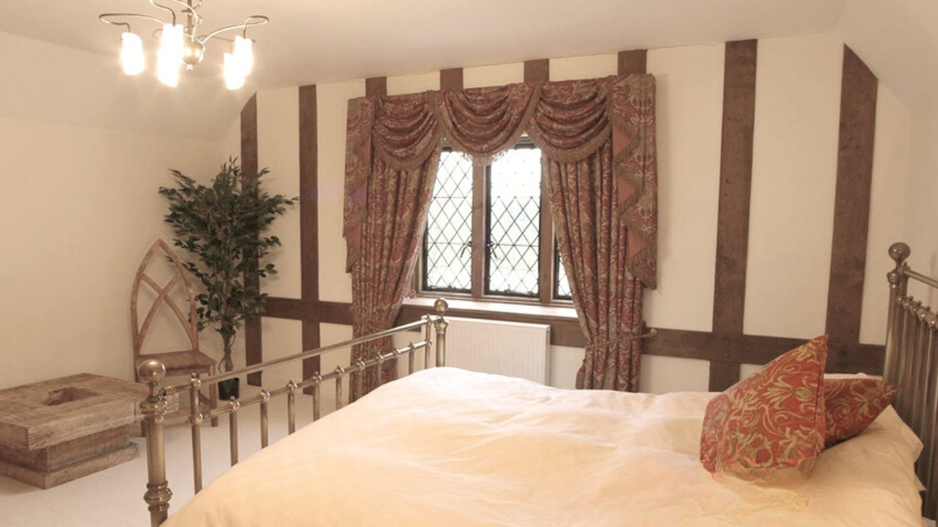 Interior cosmetic oak cladding on bedroom walls gives character and charm to the space.