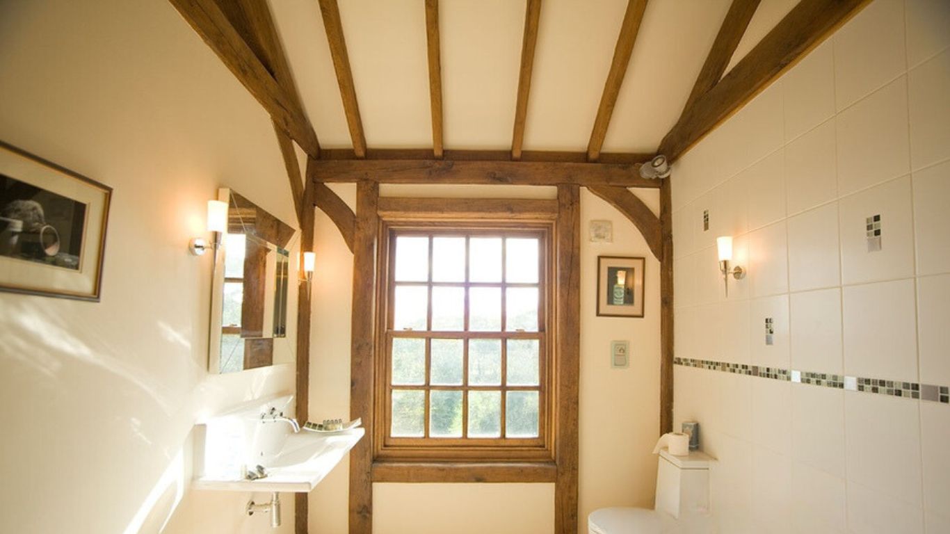 Oak components surrounding the window in the bathroom, providing concealment and support