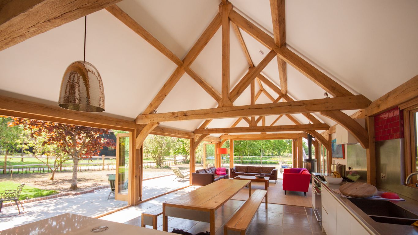 Oak king post trusses create vaulted ceiling in a kitchen extension