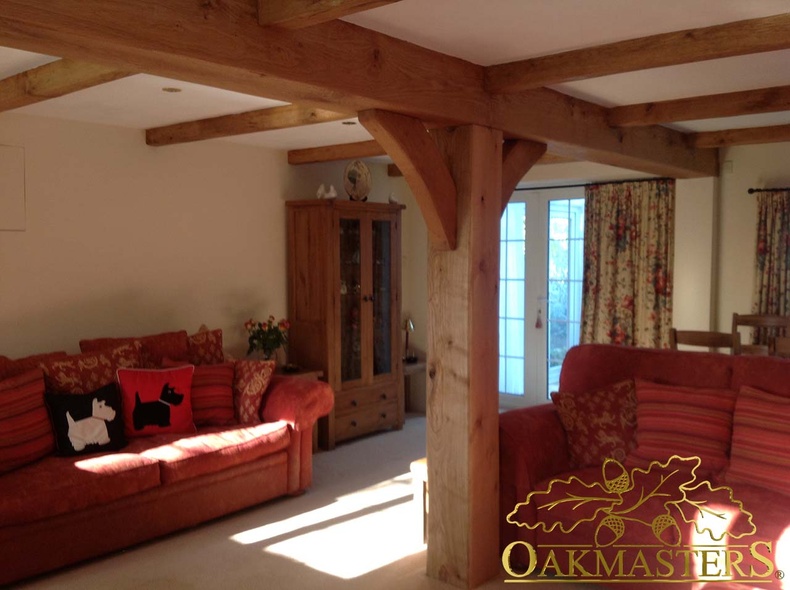 Oak post and brackets supporting an encased steel joist