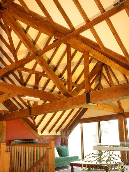 Suspended steel joist with oak beam casing and a metal strap