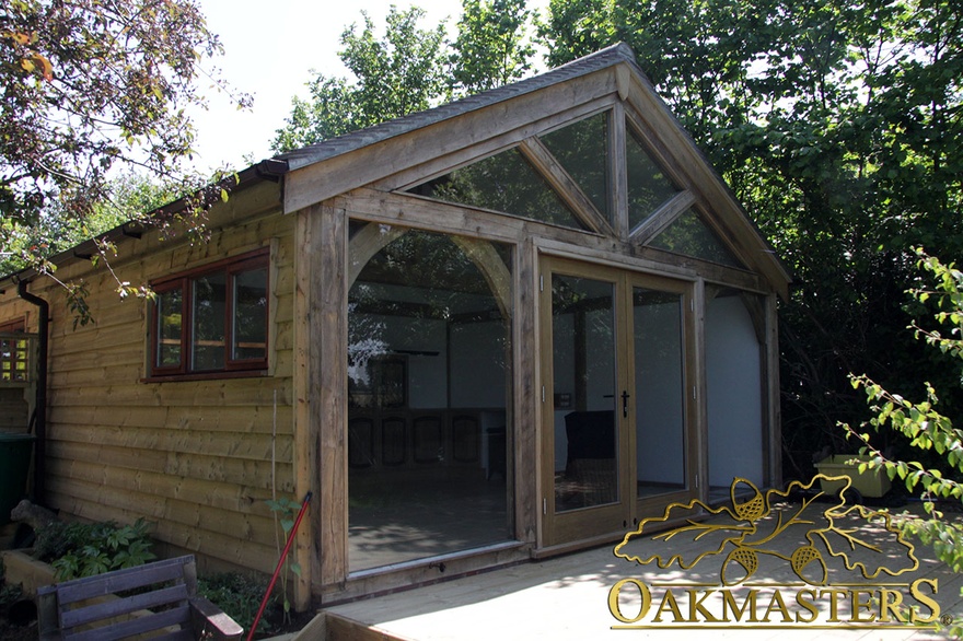 Fully glazed wall of garden room and two bay garage