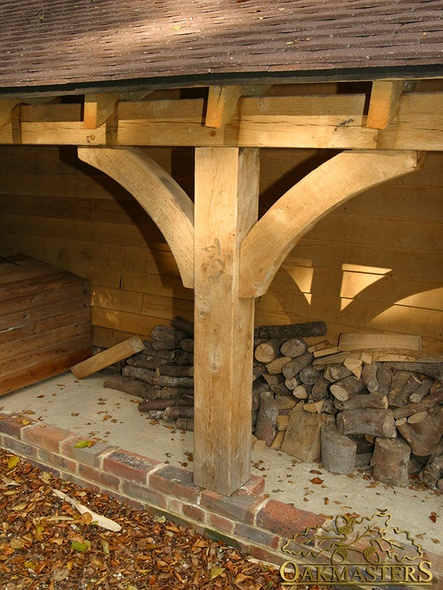 Detail of oak post and bracket of an open log store