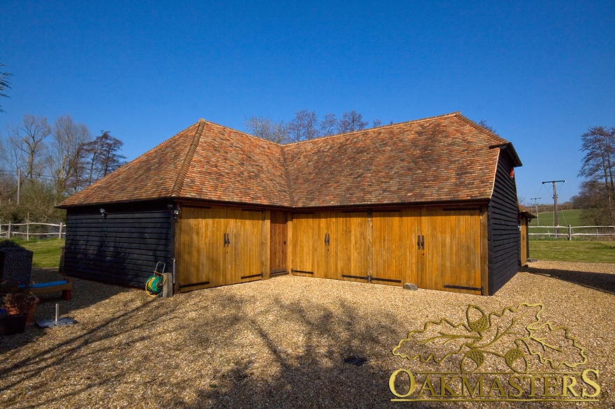 3 bay closed L shaped oak framed garage with log store