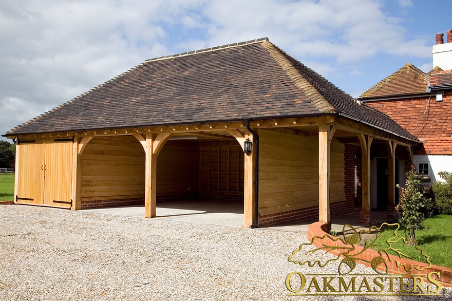 Three bay oak framed garage linked to a house with a walkway