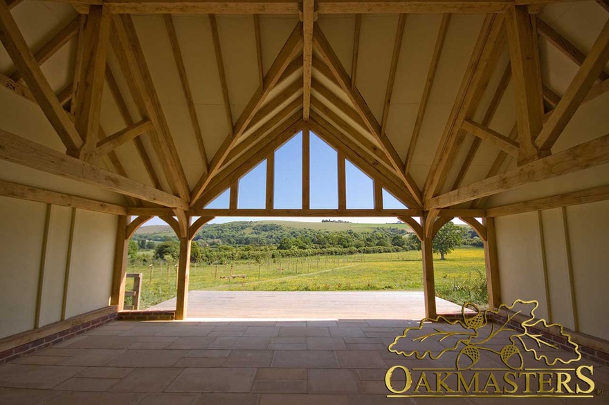 View out through a glazed gable of an oak framed outbuilding