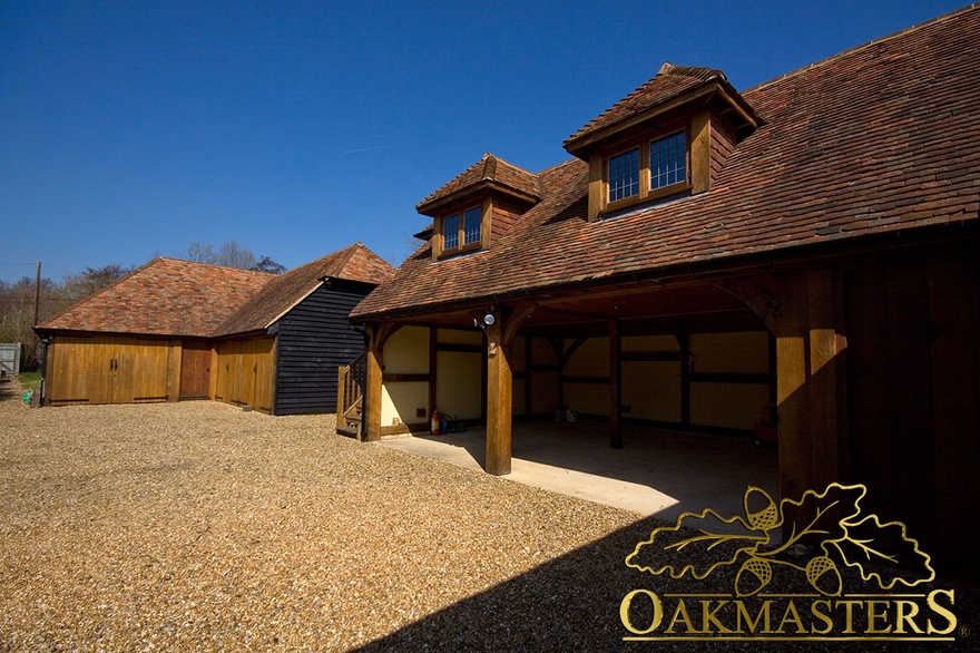 Two open oak framed garage bays with dormer windows