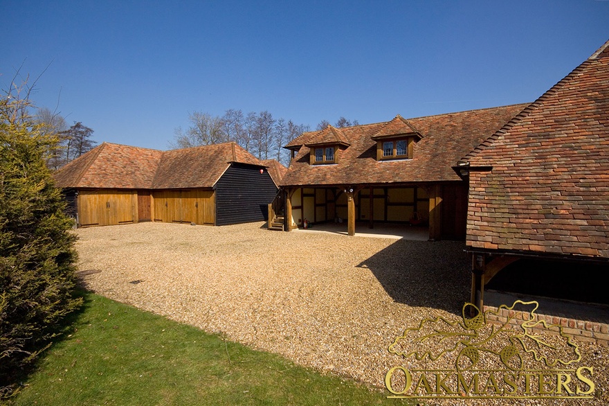 Courtyard formed by two oak framed garages and outbuildings