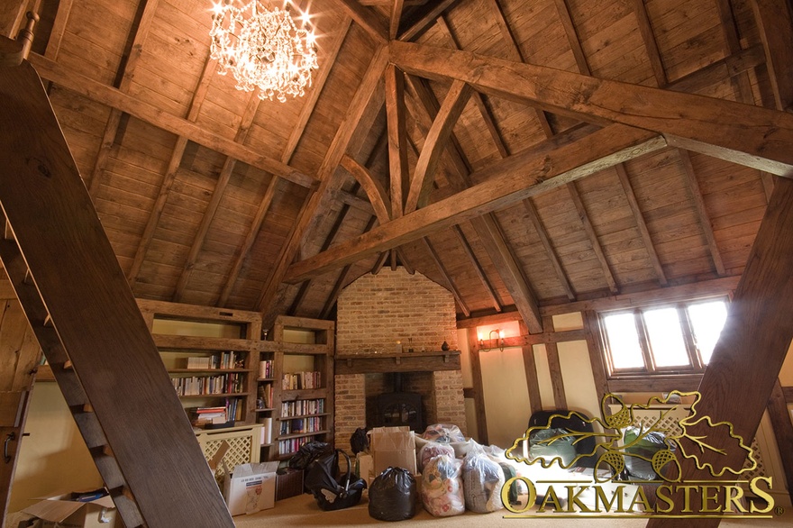 Cosy fireplace corner with oak king post truss