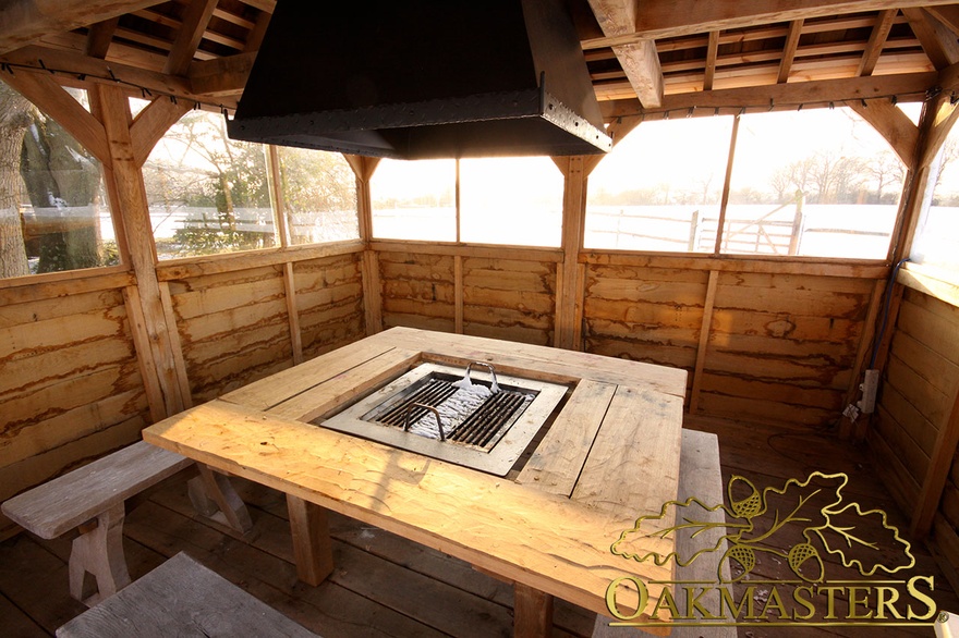 Spacious integrated barbeque and seating area within open aspect oak timber grill house