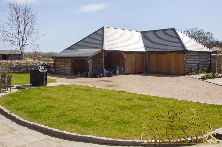 L-shaped garage and outbuilding with utility room and gym to rear of closed bays