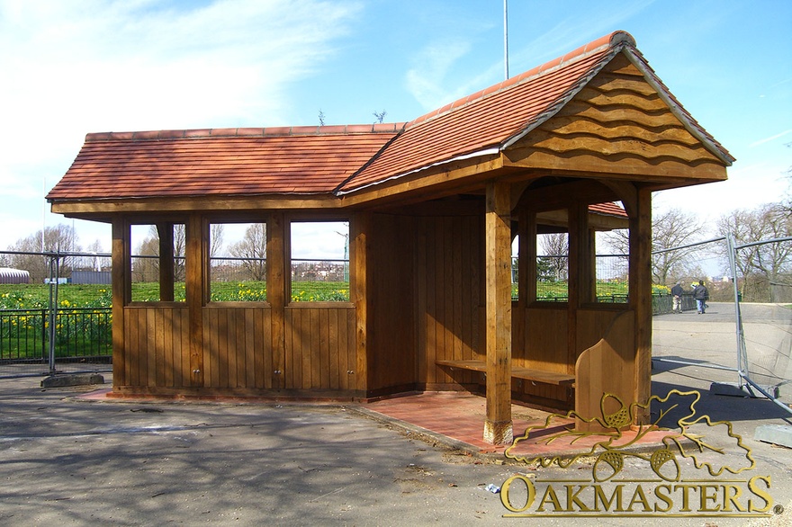 Dual sided oak seated covered park rainshelter