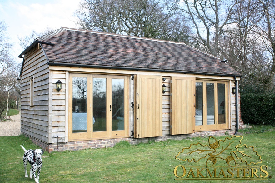 Single storey garden guest house with external oak doors 