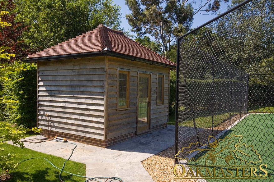 Tennis court changing room with oak frame and featheredge cladding