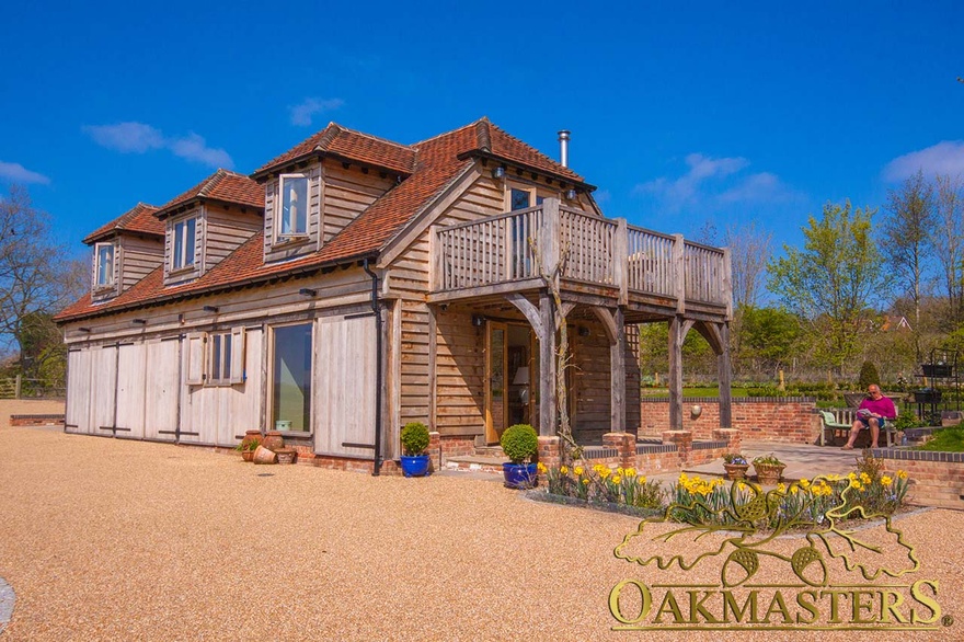 Oak frame and featheredge clad retirement home with garage and balony