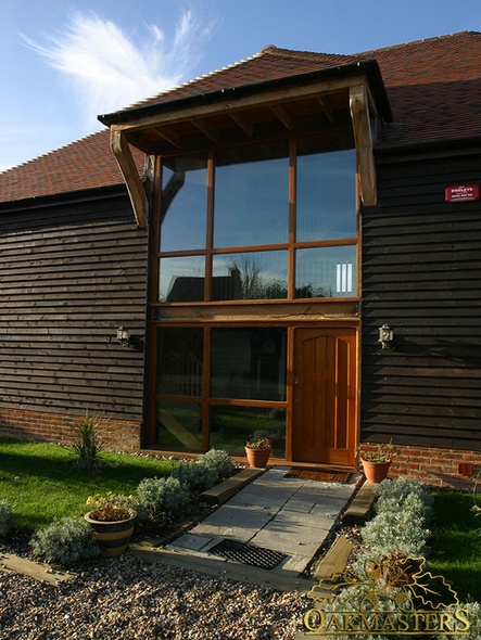 Oakframed glazing and door under projecting roof and supporting oakbraces