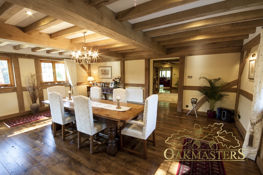Ceiling rafters and exposed oak-frame in country style dining room